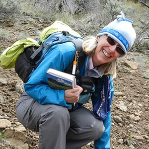 Jane Meissner smiles for a photo with plant guide in hand. Photo: Carolyn Waissman.