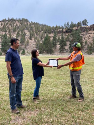 Crestline Construction is presented a certificate to recognize their efforts to fight the Grandview Fire. Photo: Land Trust.