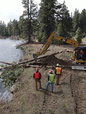 Large wood is placed in the river at the Metolius River Preserve. Photo: Land Trust.