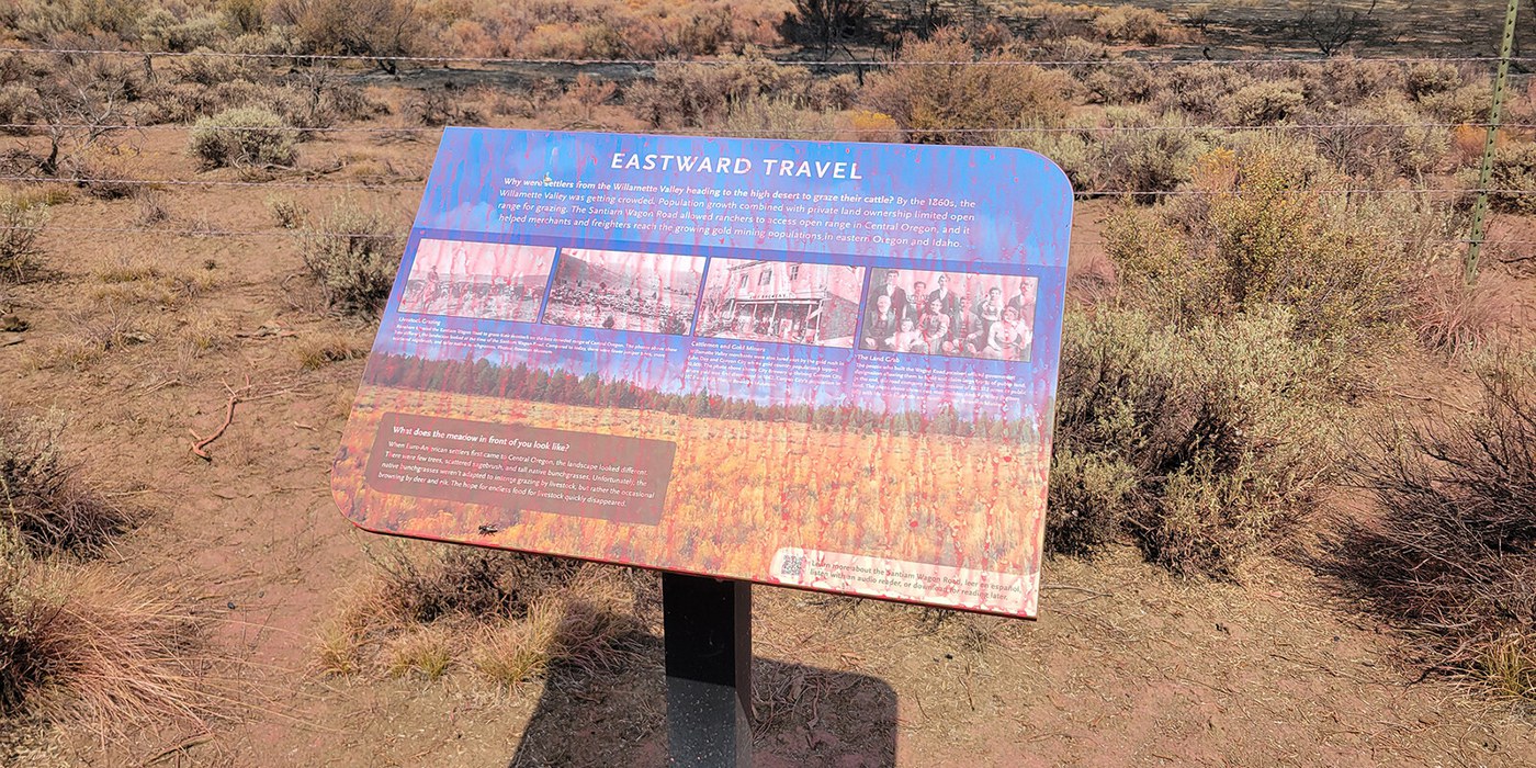 An interpretive sign is covered in fire retardant along the Santiam Wagon Road. Photo: Kurt Hunt.