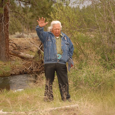 Chief Delvis Heath from the Confederated Tribes of Warm Springs gives a blessing for the first steelhead to be released in Whychus Creek at a 2007 event. Photo: John Hutmacher.