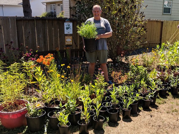 Dennis and his tiny monarch waystation filled with milkweed. Photo: Robert Coffan.