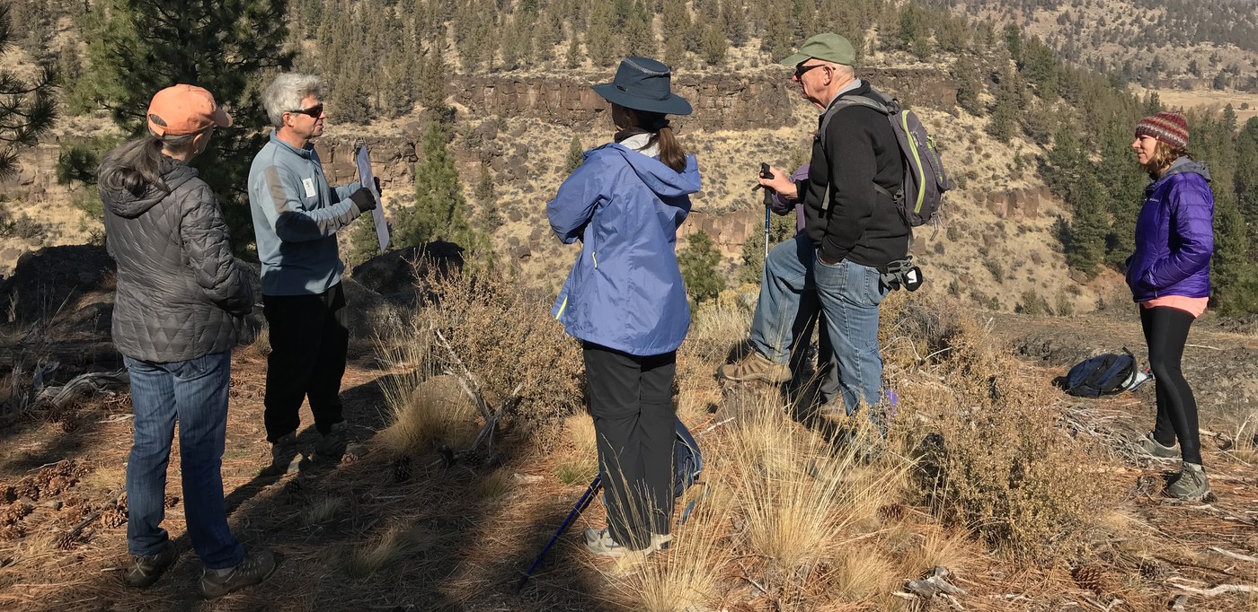 Hikers learn about our local geology as hike leaders point out a fault line. Photo: Joan Amero