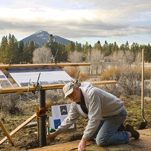 Dick Tipton installing interpretive sign. Photo: Land Trust.