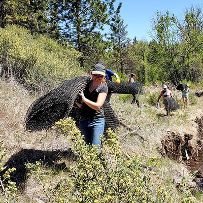 Volunteers remove fencing at Whychus Canyon Preserve. Photo: Wanderlust Tours.