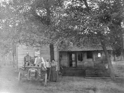 The Hindman home, viewed from the east. Left to right: Gust Olson, Samuel Hindman, Charley Hindman, Martha Taylor Cobb Hindman, and a 1903 Packard car (c. 1918). Photo: courtesy of Jan Hodgers.