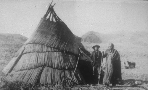 Sahaptin woman and man outside tipi covered with woven tule mats. Photo: Deschutes County Historical Society.